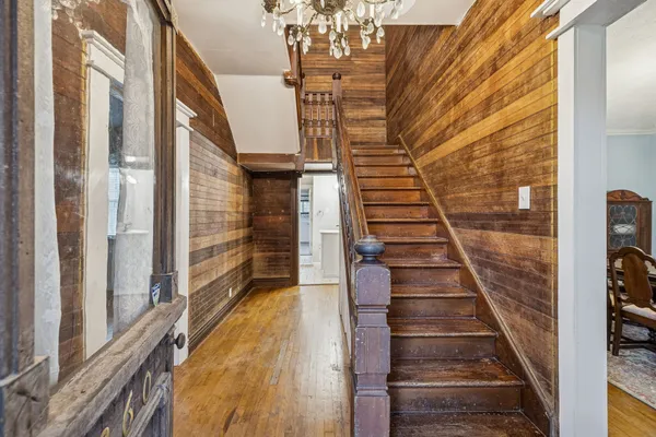 a view of a dining room with furniture and a chandelier