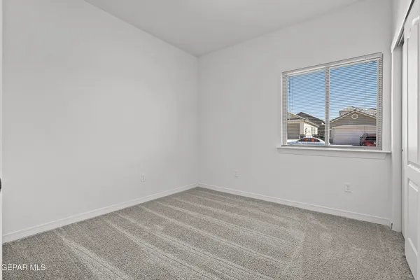 a view of a livingroom with wooden floor and a window