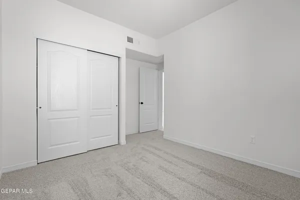 an empty room with closet area