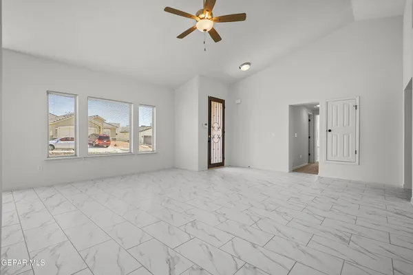 a view of an empty room with window and cabinet