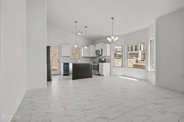 a view of a kitchen with a sink and a refrigerator