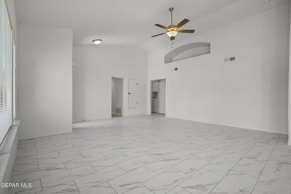 a view of an empty room with a ceiling fan