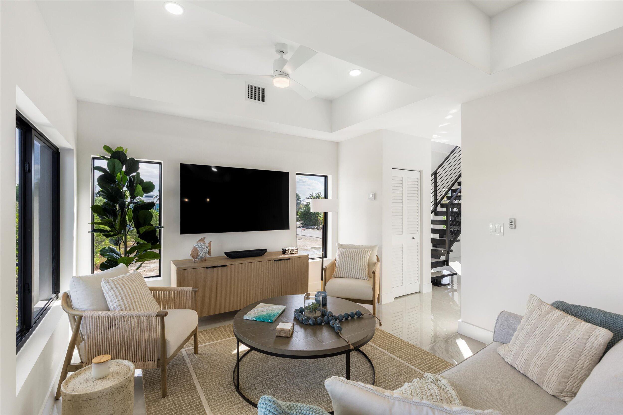27433 Antigua Road Summerland Key, FL 33042 - Photo 16 of 64 a living room with furniture and a flat screen tv