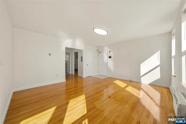 a view of a bedroom with wooden floor and bedroom