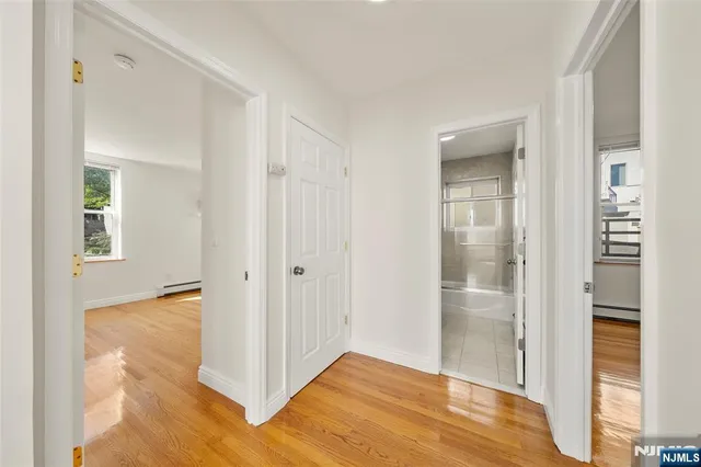 a view of hallway with wooden floor