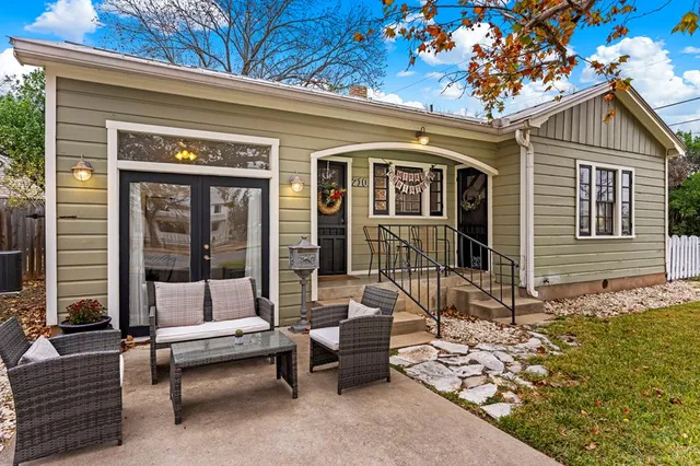 a view of a house with a couch and wooden bench
