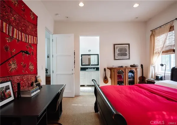 a bedroom with a large bed and a large window