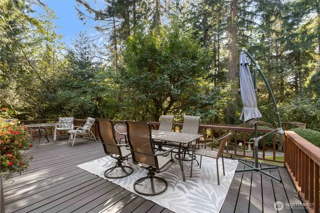 a view of a dinning table and chairs on the roof deck