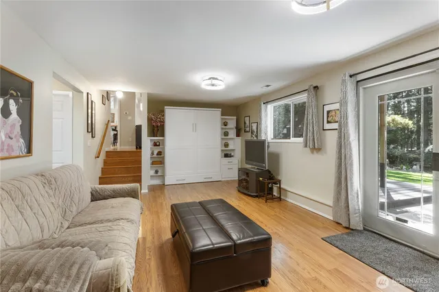 a living room with furniture and wooden floor