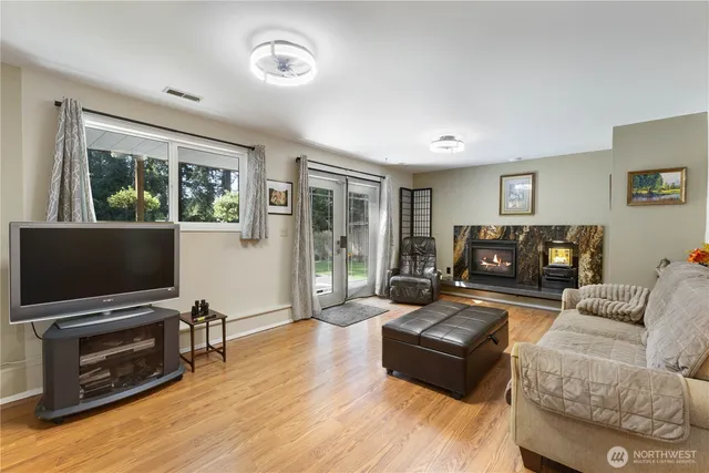 a living room with furniture a flat screen tv and a fireplace