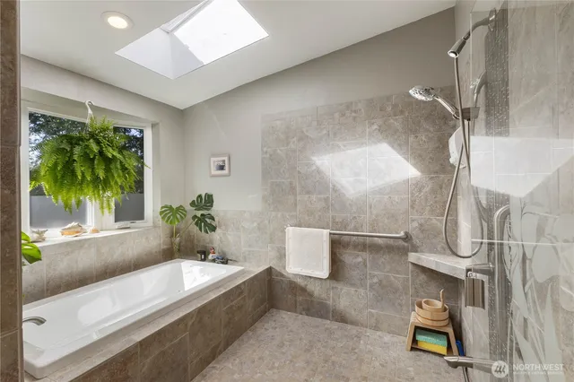 a bathroom with a tub shower and mirror