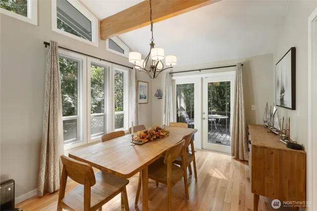 a view of a dining room with furniture large windows and wooden floor