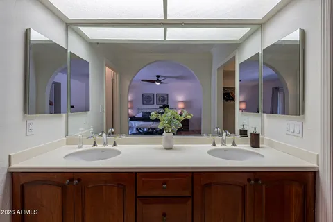 a bathroom with a granite countertop sink a large mirror and a