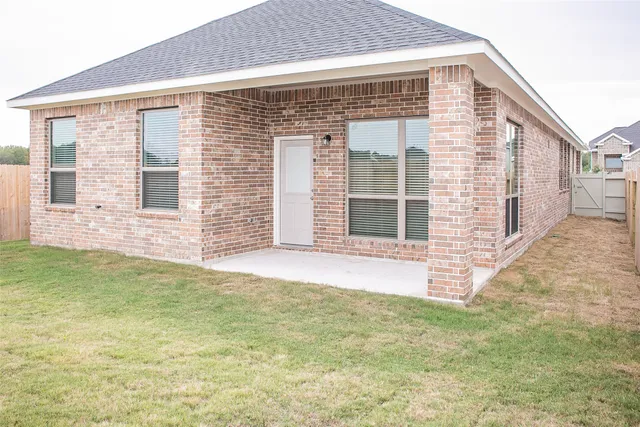 a view of a backyard with a garden and entryway
