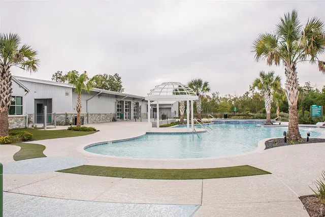 a front view of a house with a yard and lake view
