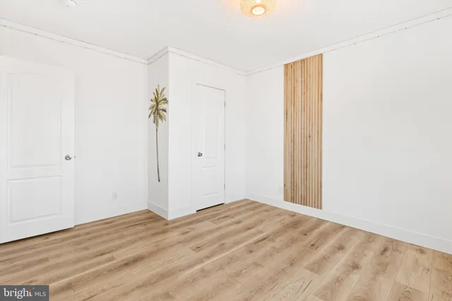 a view of a room with wooden floor