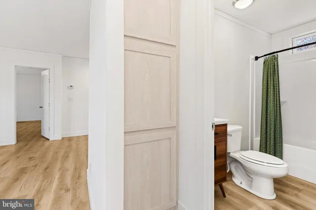 a white toilet sitting next to a bathroom sink
