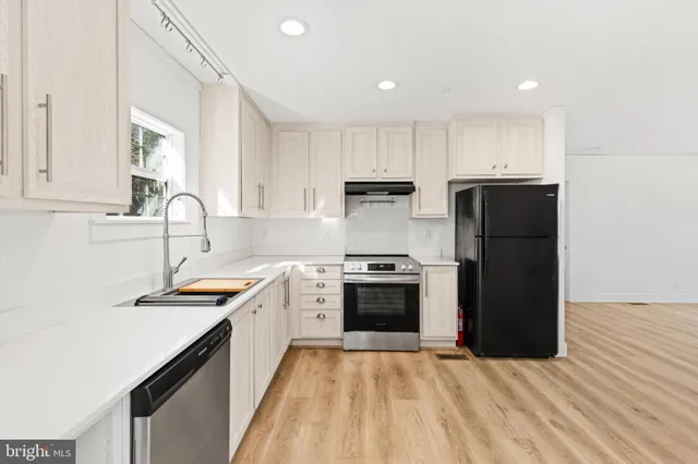 a kitchen with a refrigerator and a sink