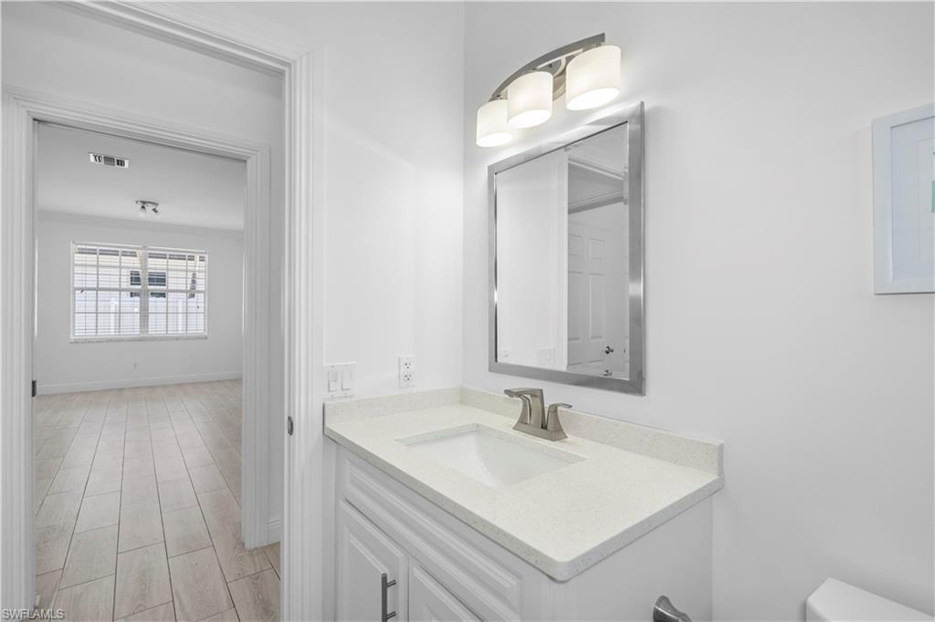 183 7th Street Naples, FL 34113 - Photo 18 of 50 a bathroom with a sink and a mirror