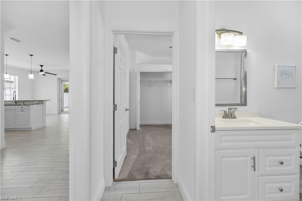 183 7th Street Naples, FL 34113 - Photo 21 of 50 a bathroom with a sink and a mirror
