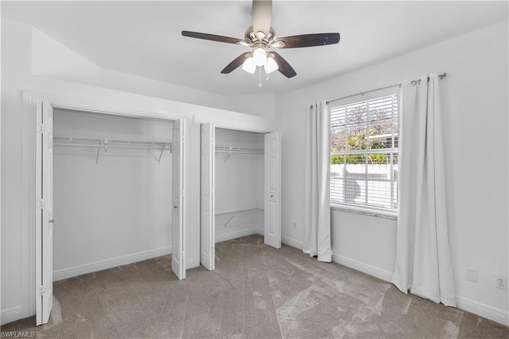 183 7th Street Naples, FL 34113 - Photo 22 of 50 an empty room with windows and fan