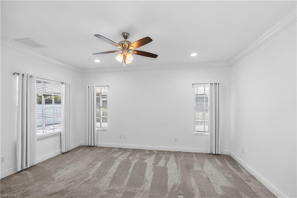 183 7th Street Naples, FL 34113 - Photo 28 of 50 an empty room with closet and a ceiling fan