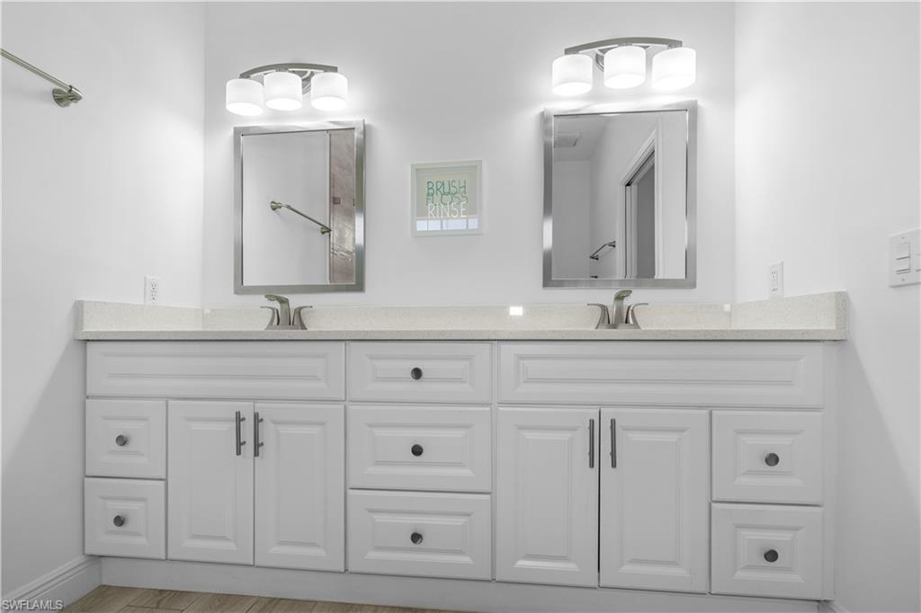 183 7th Street Naples, FL 34113 - Photo 31 of 50 a bathroom with white cabinets and sink