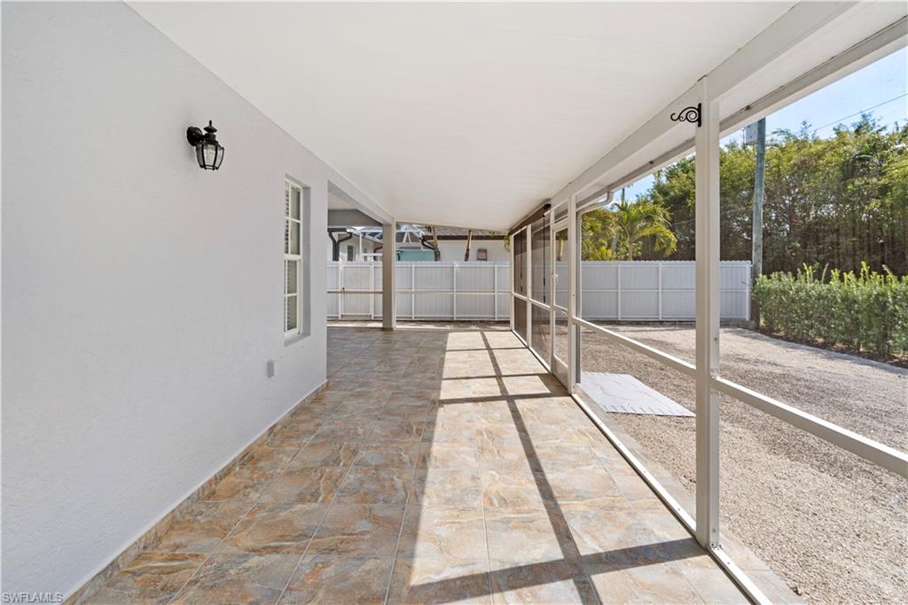 183 7th Street Naples, FL 34113 - Photo 37 of 50 a view of a large room with wooden floor and windows