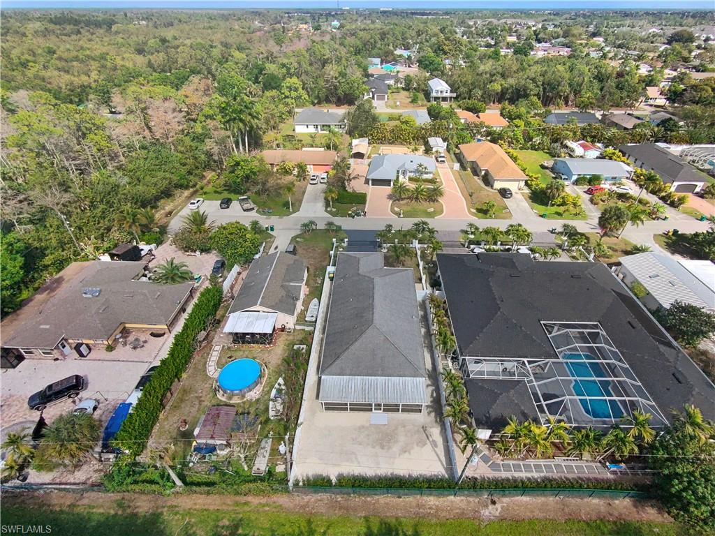 183 7th Street Naples, FL 34113 - Photo 48 of 50 an aerial view of residential houses with outdoor space and parking