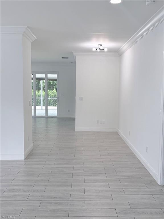 183 7th Street Naples, FL 34113 - Photo 8 of 50 a view of an empty room with a window