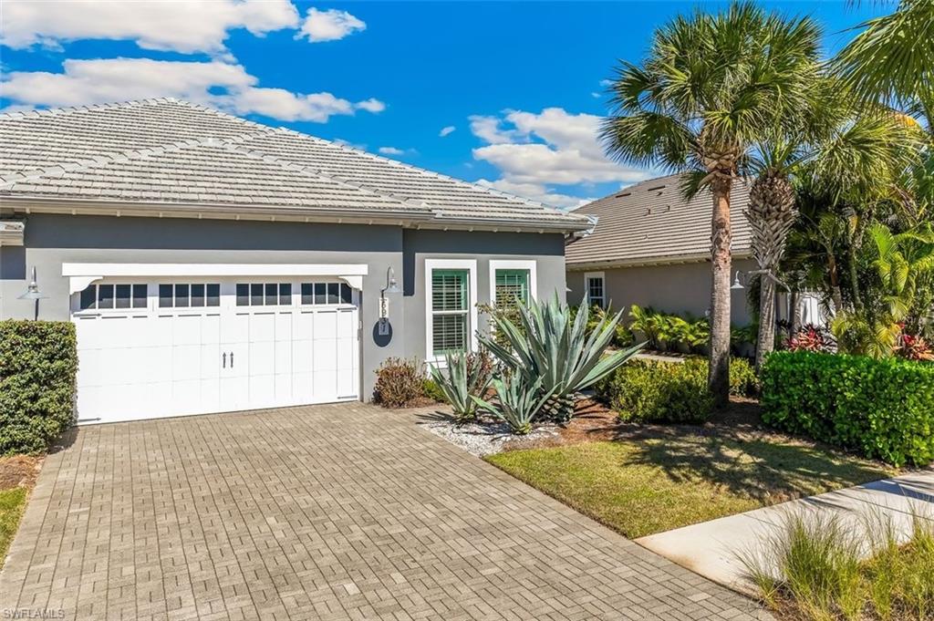 6931 Cay Court Naples, FL 34113 - Photo 2 of 24 View of front of property with stucco siding, a tiled roof, decorative driveway, and a garage