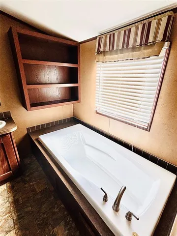 a bathroom with a glass shower door