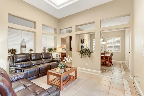 a view of living room with a window and a ceiling fan