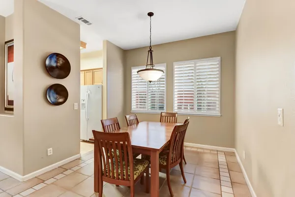 a view of a dining room with a table and chairs
