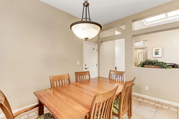 a view of a dining room with furniture and chandelier