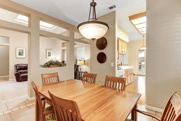 a kitchen that has a lot of cabinets in it and wooden cabinets