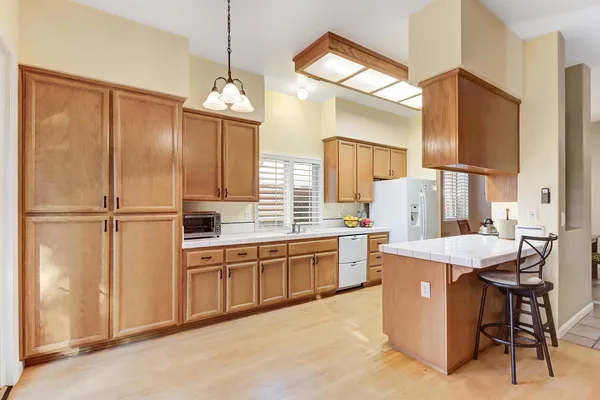 a kitchen with stainless steel appliances white cabinets and a refrigerator
