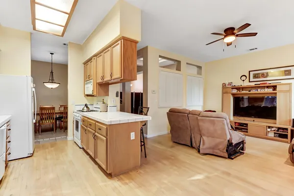 a kitchen with stainless steel appliances granite countertop a lot of counter space and a window