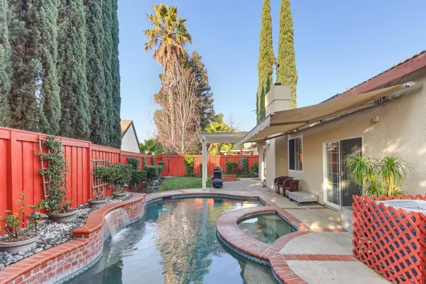 a swimming pool with outdoor seating and yard