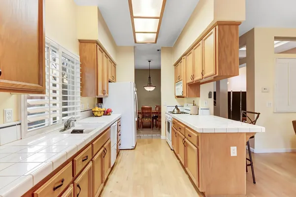 a kitchen with stainless steel appliances granite countertop a sink and cabinets