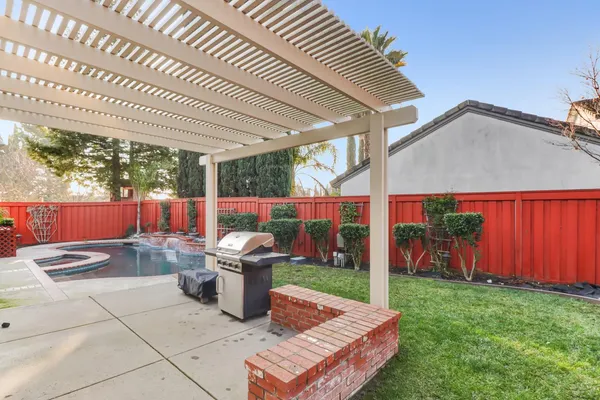 a view of a house with swimming pool and sitting area