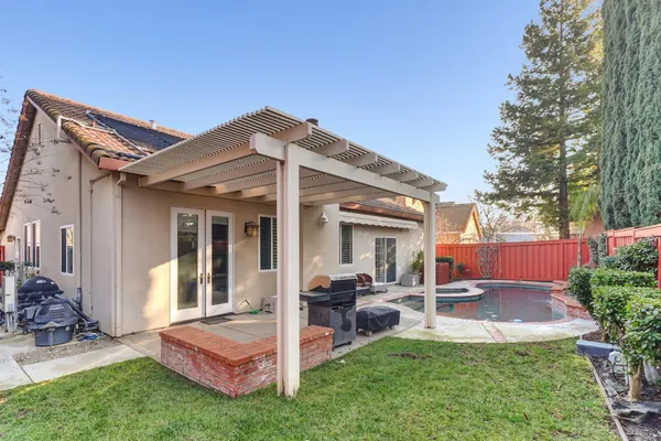 a view of a house with a swimming pool and sitting area