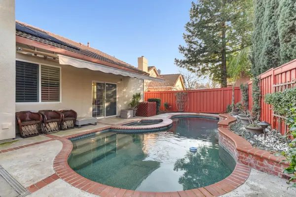 a view of a backyard with plants and outdoor seating