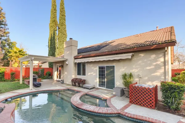 a view of swimming pool with a yard