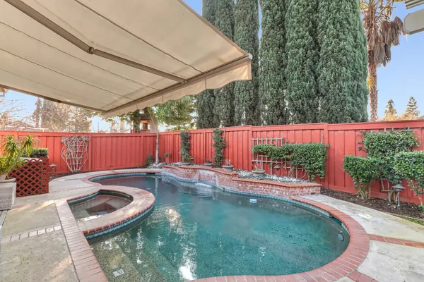 a view of swimming pool with outdoor seating and plants