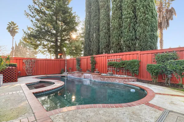 a backyard of a house with garden and outdoor seating