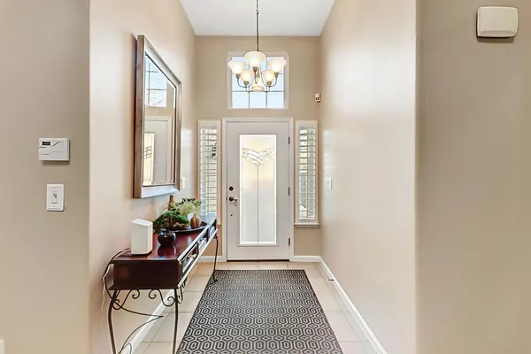 a living room with furniture and a mirror