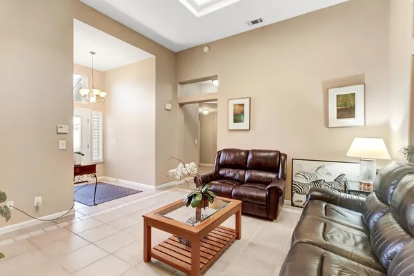 a living room with furniture and a chandelier