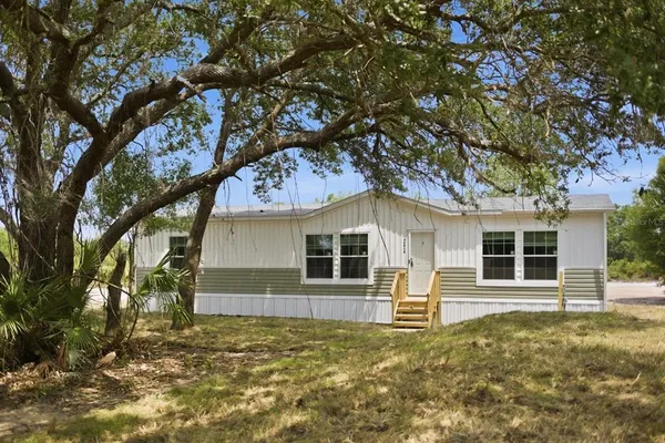 front view of a house with a tree