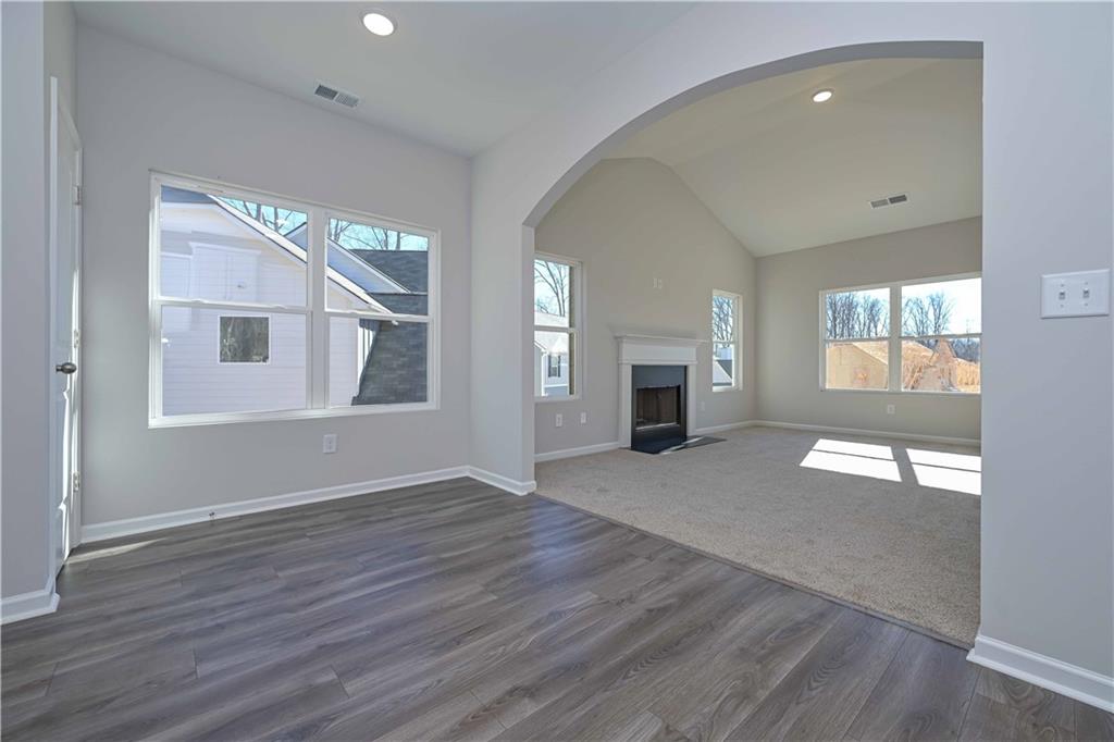 506 Charleston Place Villa Rica, GA 30180 - Photo 13 of 25 a view of an empty room with wooden floor and a window
